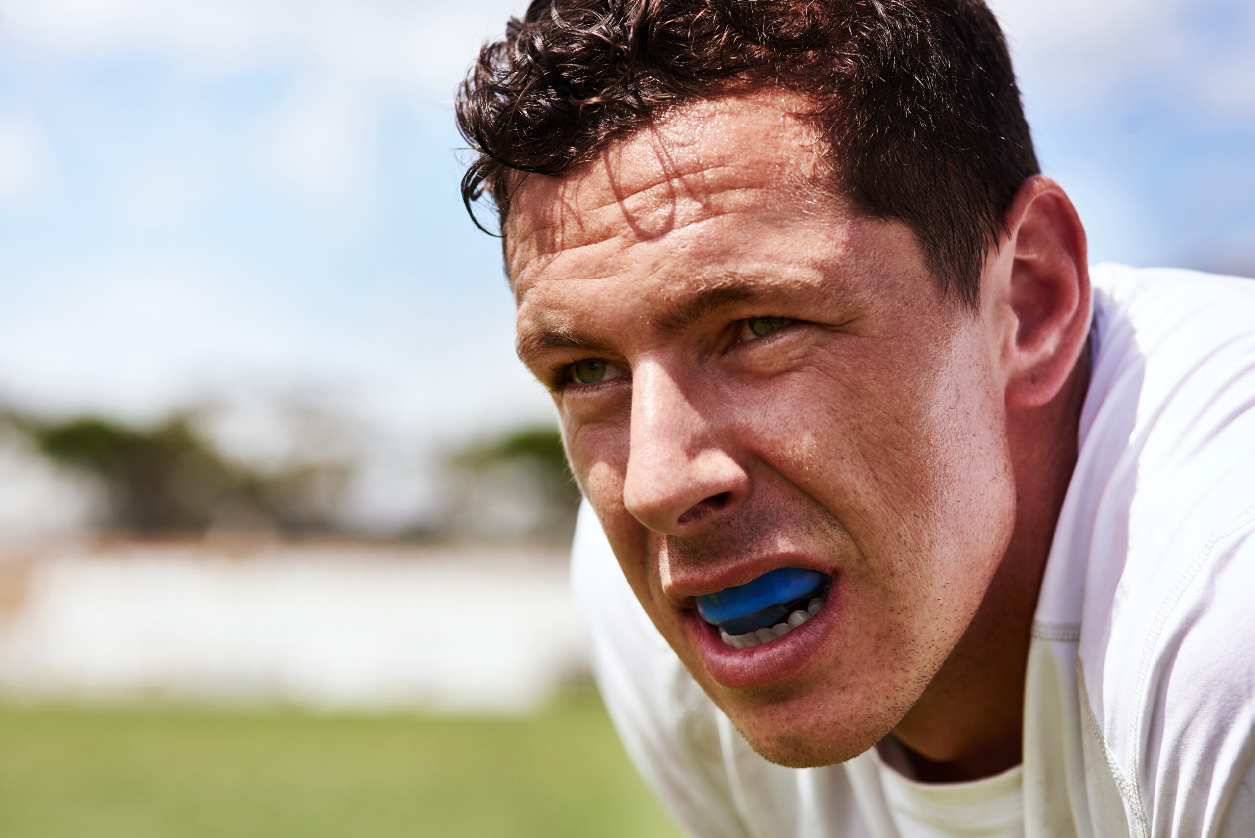 Young man wearing a mouth guard while playing a game of football.