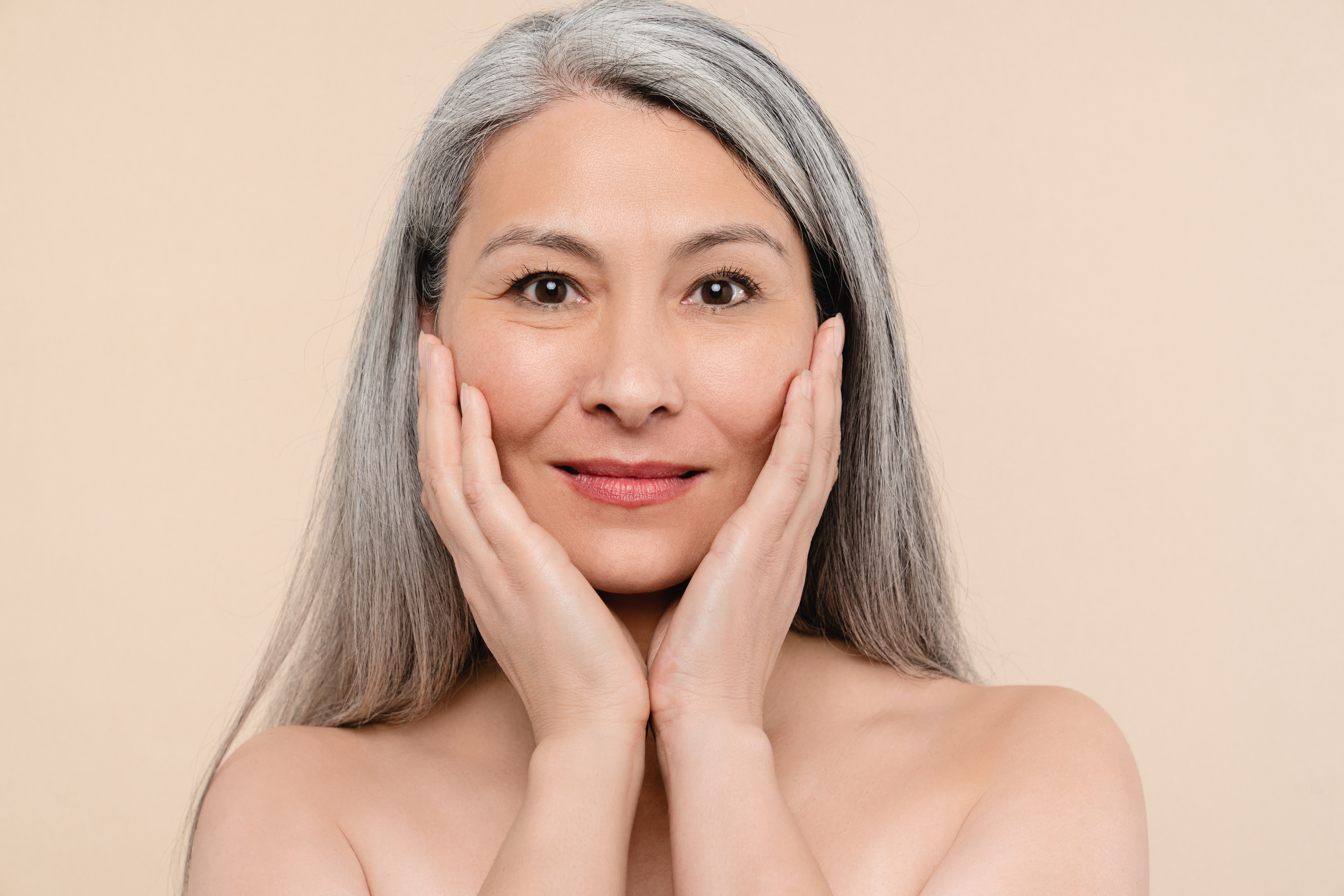 Middle-aged woman with glowing, healthy skin.