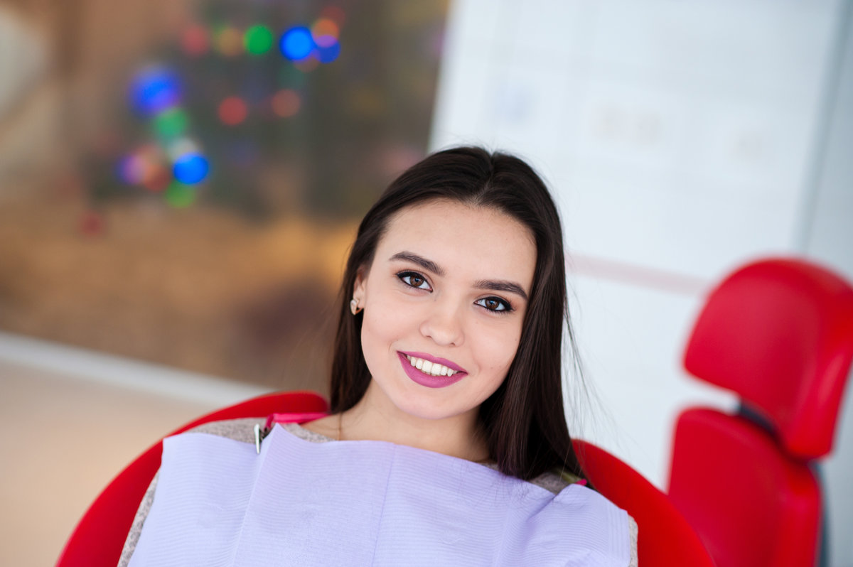 Beautiful girl smiling in the dental chair.