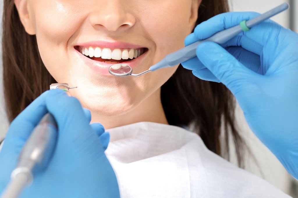 Close-up of a woman's mouth during a dental exam, relevant to how GLP-1 medications can affect oral health