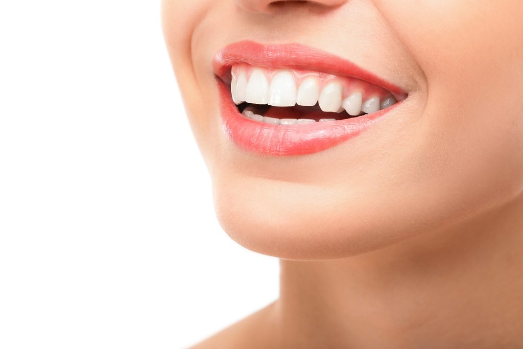 Woman with a bright, healthy smile after a smile makeover