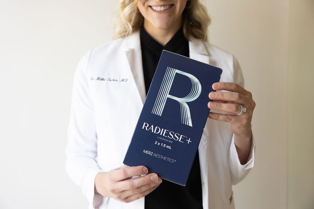 Dental professional holding Radiesse+ aesthetic injection product box