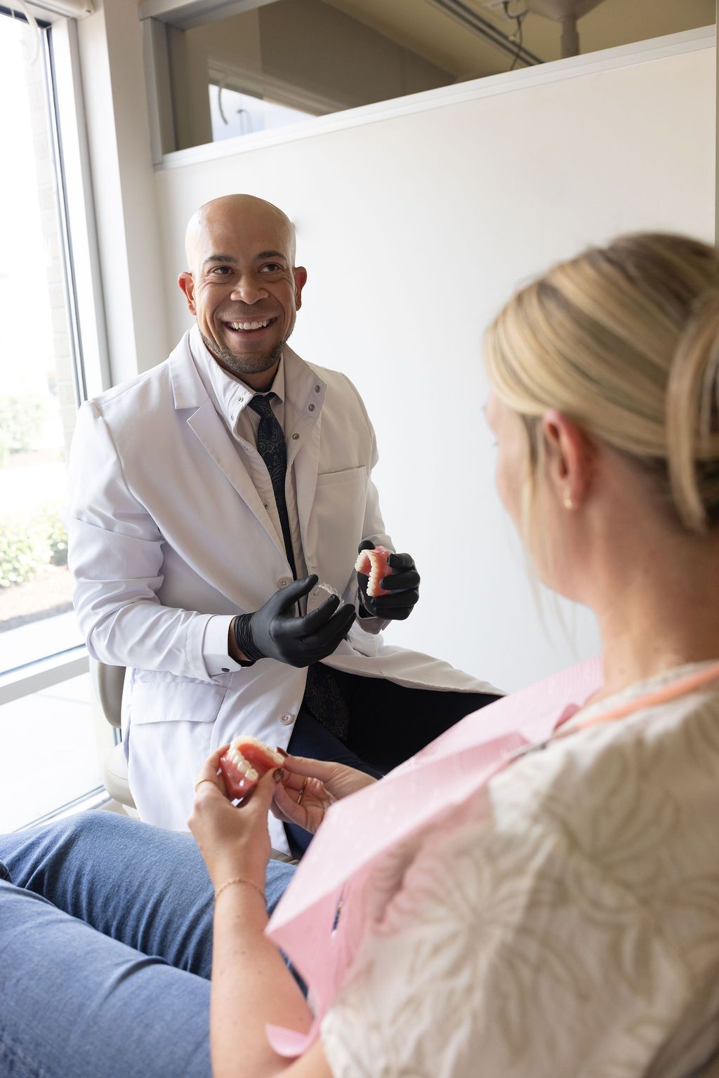 Sunrise Dental Cary dentist discussing dental implant treatment with patient in office