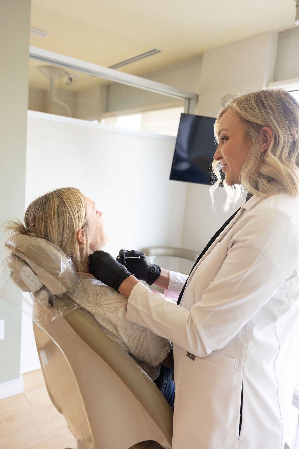 Sunrise Dental Cary dentist discussing treatment with young patient in exam chair