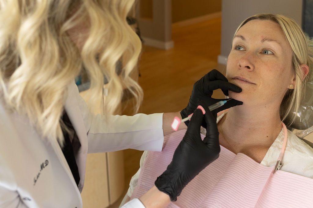 Sunrise Dental Cary dentist performing intraoral examination with handheld light on patient