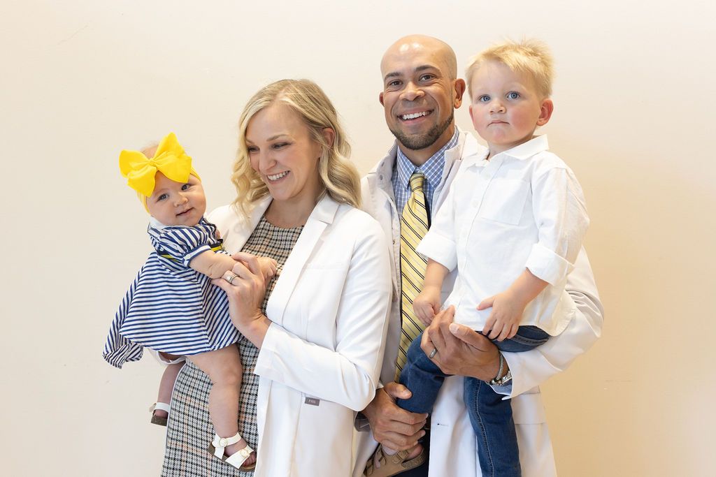 Sunrise Dental Cary dentist and hygienist with two children in white coats